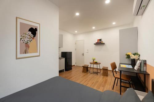 a room with a bed and a table and a kitchen at Fuji Hotel and Apartment Cau Giay in Hanoi