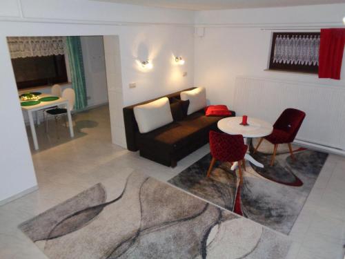 a living room with a couch and a table at Ferienwohnung "Am Recknitzhang" in Daskow