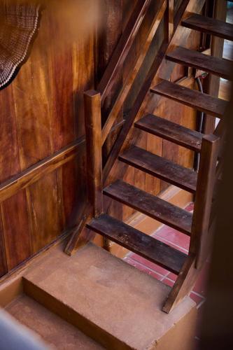 a set of wooden stairs in a room at Mật Retreat in Ba Vì