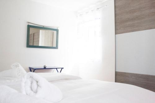 a bedroom with two white beds and a mirror at Royal 4 Trend by Alpenidyll Apartments in Liezen