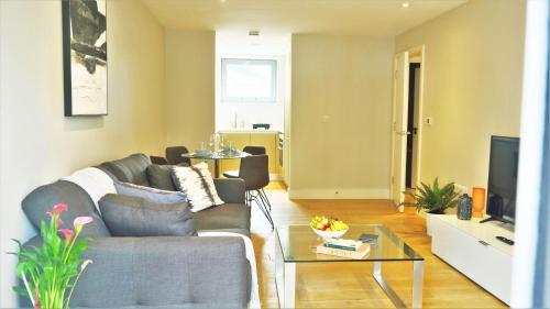a living room with a couch and a table at Spacious & Elegant Apartments in Southbank near London Eye in London