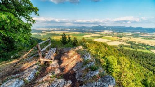 a bench on the edge of a mountain overlooking a valley at Ondrašovská skala in Ondrašová