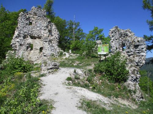 a dirt trail in front of an old stone building at Ondrašovská skala in Ondrašová