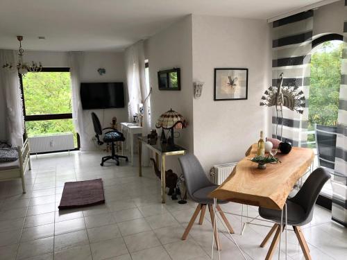 a living room with a table and chairs at Apartment Naheblick in Bad Kreuznach