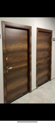 a pair of wooden doors in a room at tsaghkadzor apartment kechi house in Tsaghkadzor