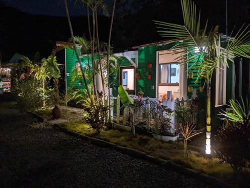 a house with a green facade at night at Ashitoku Bungalow - Vacation STAY 67581v in Akaoki