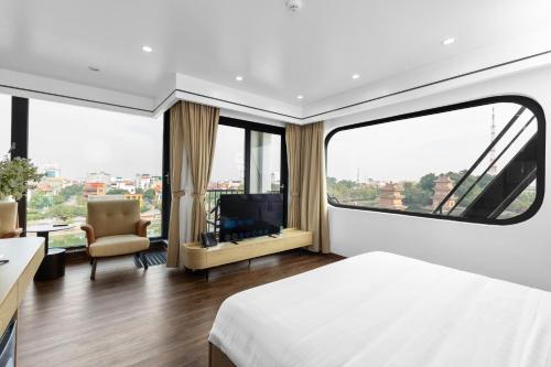 a hotel room with a bed and a large window at Khách sạn Phố cổ Hotel Ninh Bình in Ninh Binh