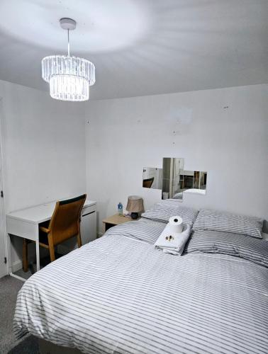a bedroom with a bed with a stuffed animal on it at Ensuite Doubleroom with Private Toilet and Bathroom in central Dartford in Dartford