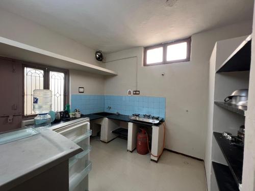 a kitchen with a sink and a table in it at SHI's 2BHK home in Coimbatore near Sai Baba Colony, Ganga C Hospital, Women's care in Coimbatore