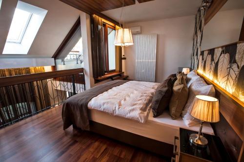 a bedroom with a bed and a balcony with windows at Zuckmann Villa in Piešťany