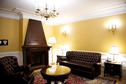 a living room with a couch and a fireplace at Forgách Kastély in Mándok