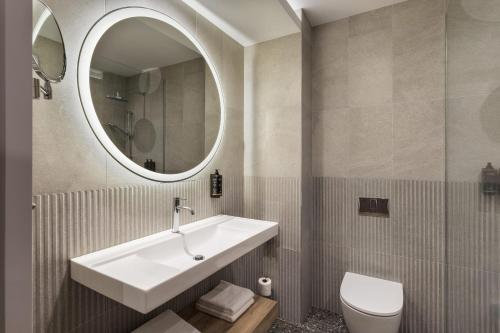 a bathroom with a sink and a mirror at Mercure Sofia City in Sofia
