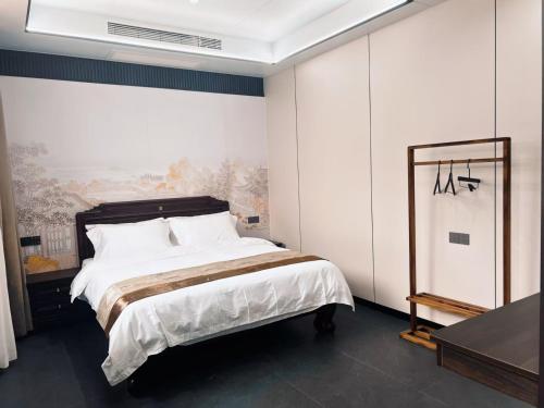 a bedroom with a large bed with white pillows at Yongjuxiang Mansion in Pingyao