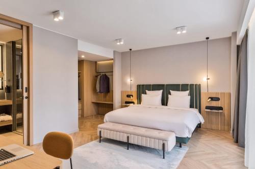 a bedroom with a bed and a desk and a laptop at Mercure Sofia City in Sofia