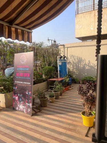 a patio with potted plants and a sign on it at HOTEL SHIVGANGA COMFORT ZONE, Raipur in Raipur