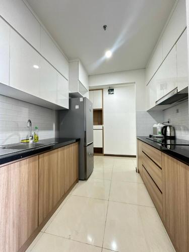 a large kitchen with black counter tops and wooden cabinets at Qhome in Ho Chi Minh City