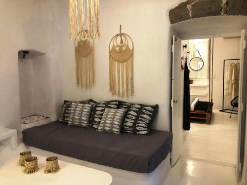a room with a bed with pillows on it at Milos Heritage Home 1883 in Adamantas