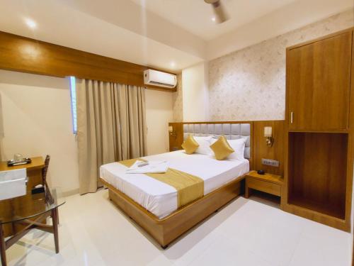 a hotel room with a bed and a window at Hotel Status Residency in Navi Mumbai