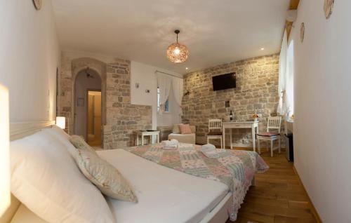 a bedroom with a bed and a living room at Luxury Room Kokola in Split