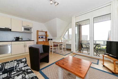 a living room with a couch and a table at Sandwall Whg 2 Langeness in Wyk auf Föhr