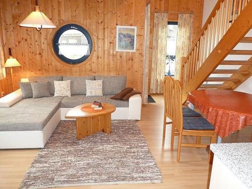 a living room with a couch and a table at Ferienhaus Nr 9B1, Feriendorf Hagbügerl, Bayr Wald in Waldmünchen