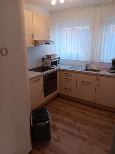 a kitchen with a sink and a stove top oven at Gästehaus Becker in Wachenheim an der Weinstraße