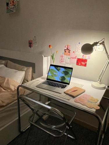 a laptop computer sitting on a desk in a bedroom at stay bnb 206 in Seoul
