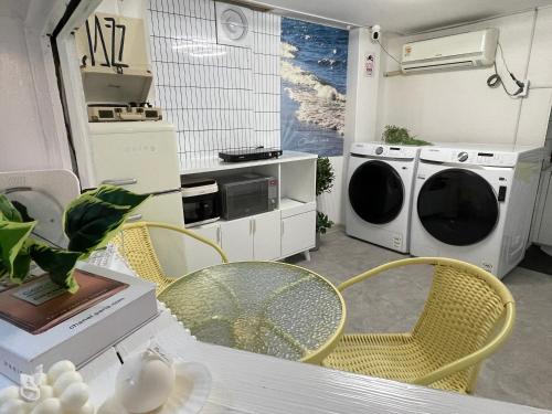 a kitchen with a table and chairs and a washing machine at stay bnb 206 in Seoul