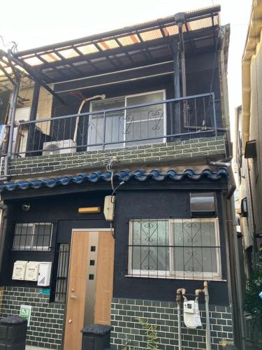 a building with a balcony on the side of it at Sun住之江 in Osaka