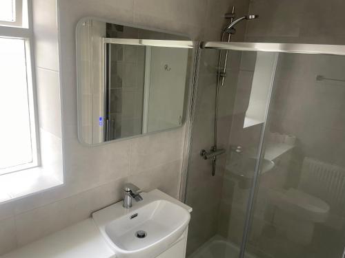 a bathroom with a shower and a toilet and a sink at The Wildings Hotel & Tudno's Restaurant in Llandudno