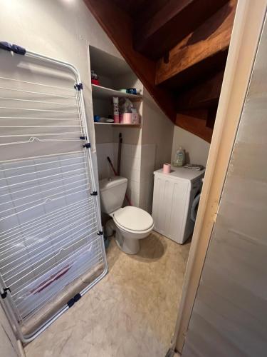 a small bathroom with a toilet and a sink at Maison calme à Allassac in Allassac