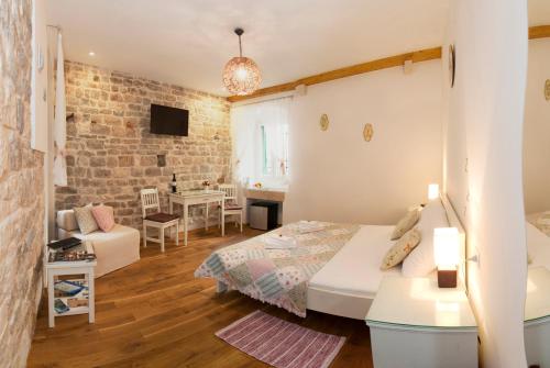a bedroom with a bed and a living room at Luxury Room Kokola in Split