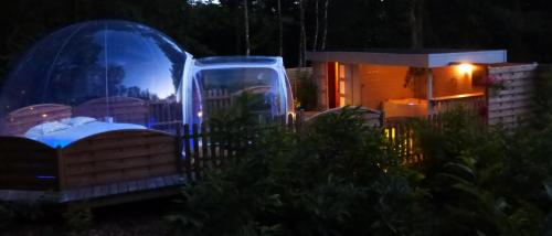 a couple of domes sitting in front of a house at Bulle d'R in Dournazac