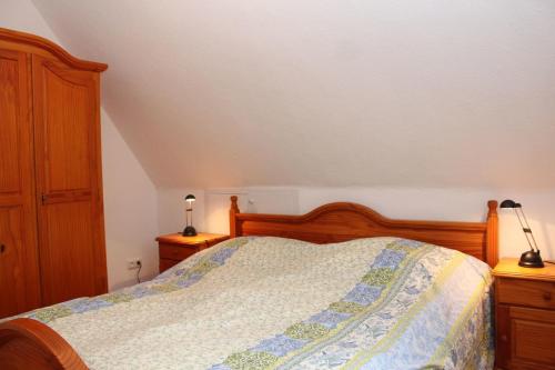 a bedroom with a bed and two lamps on night stands at Dat Huuske in Gerdau
