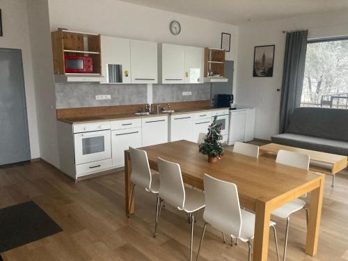 a kitchen and dining room with a wooden table and chairs at KuK Račice in Račice