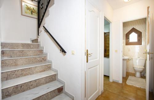 a hallway with stairs and a bathroom with a toilet at Casa Vera in Torrevieja