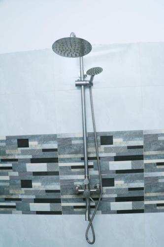 a shower in a bathroom with a glass wall at GVN villa in Ahangama