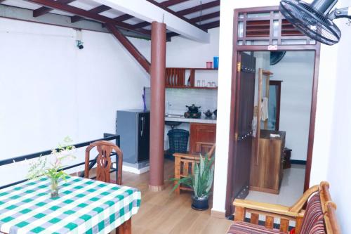 a dining room with a table and chairs in a room at GVN villa in Ahangama