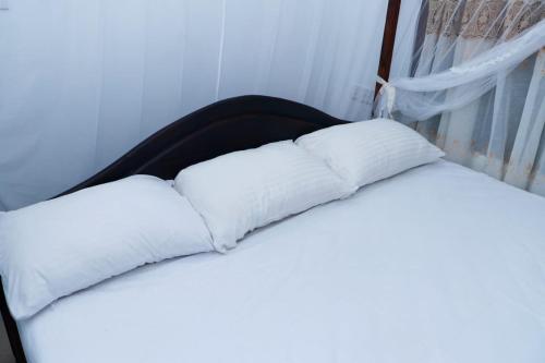 two white pillows sitting on top of a bed at GVN villa in Ahangama
