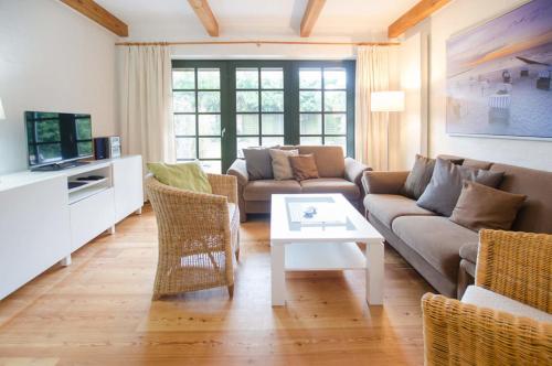 a living room with a couch and a table at Haus Schünemann 4 in Kellenhusen