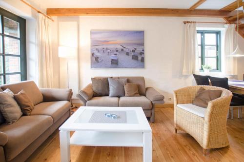 a living room with a couch and a table at Haus Schünemann 4 in Kellenhusen