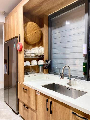a kitchen with a sink and a window at M&M Homestay in Hue