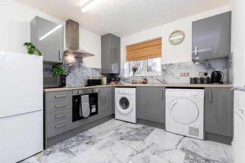 a kitchen with a washer and dryer at Quiet corner haven in Guisborough