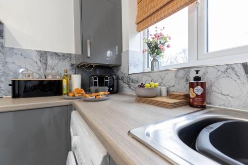 a kitchen counter with a sink and a window at Quiet corner haven in Guisborough