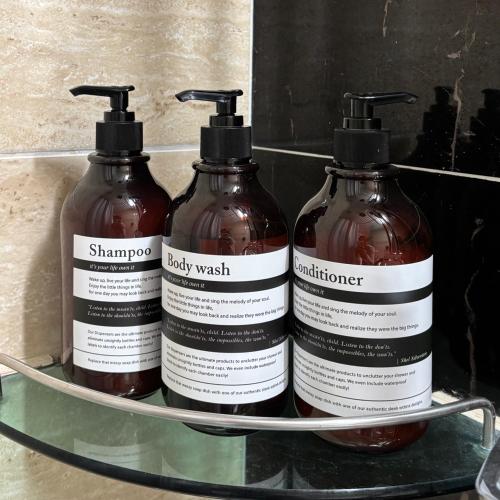 three bottles of soap on a glass shelf at Moneystay Daegu Palgongsan in Daegu
