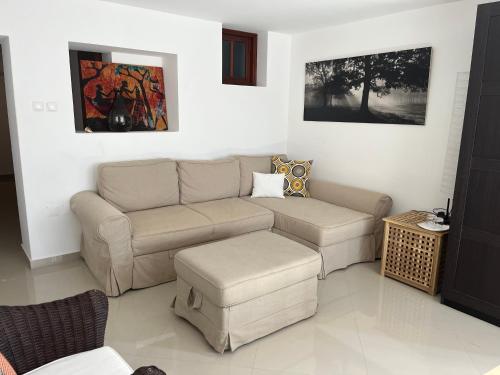 a living room with a couch and a table at Vila Mira Mar in Mindelo