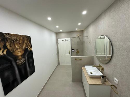 a bathroom with a sink and a mirror at morand I Apartments in Salzburg