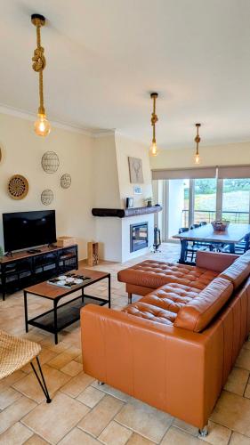 a living room with a couch and a table at Casa da Barragem da Vigia in Redondo