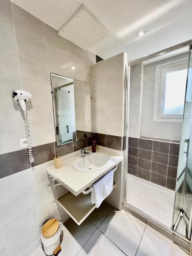 une salle de bain avec un lavabo et une douche dans l'établissement La Côtière, Terrasse et Jardin RDC, Proche plage, à Saint-Palais-sur-Mer