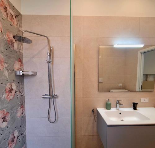 a bathroom with a shower and a sink at Azzurro Mare Aparthotel in Torre Mozza